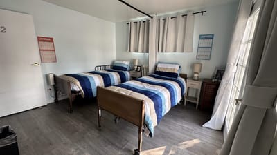 Private room with two beds and soft lighting