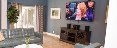 A cozy lounge area with comfortable seating and television