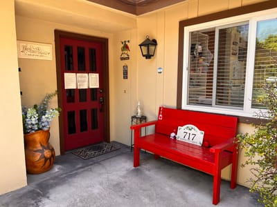 Entrance with a red bench and decorative vase