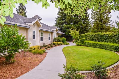 Pathway leading to a senior living facility surrounded by greenery