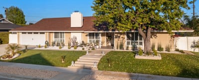Exterior view of a senior living facility with gardens