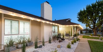 Exterior view of Cinnamon Garden Home with landscaped area