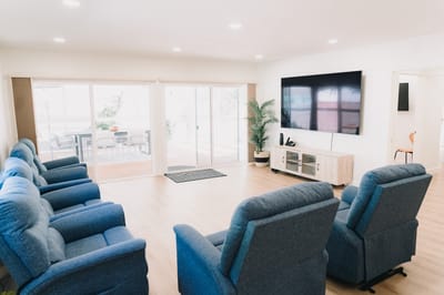 Interior common area with recliners and a TV