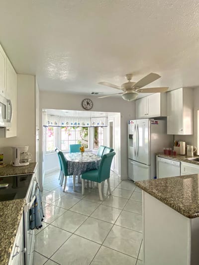 Bright kitchen area with a dining table and chairs