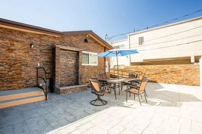 Outdoor patio area with seating and umbrella