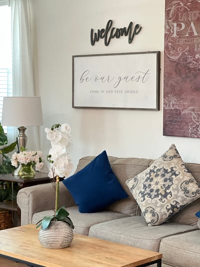 Cozy living room with welcome sign and decorative pillows