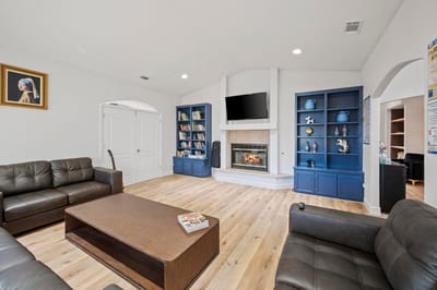 Bright common area with comfortable seating and a fireplace