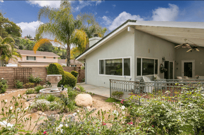 Outdoor view of a cottage with a garden and seating area