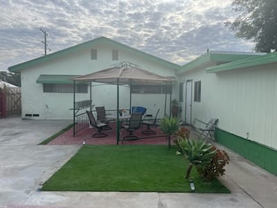 Outdoor seating area with gazebo and grass lawn