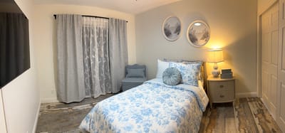 Cozy private room with blue floral bedding and decor