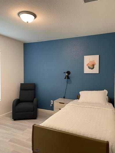Cozy resident room with a single bed and chair