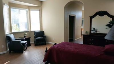 A well-furnished resident room with natural light