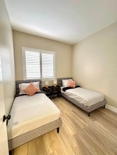 Brightly lit shared resident room with two beds