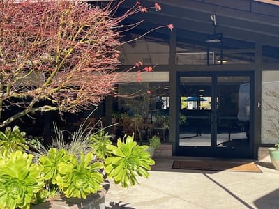 Entrance of a senior living facility with outdoor plants