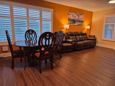 Bright common area with dining table and seating