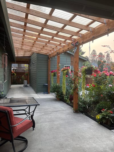 Outdoor patio area with flowers and seating