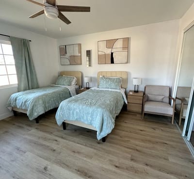 Brightly lit shared bedroom with twin beds