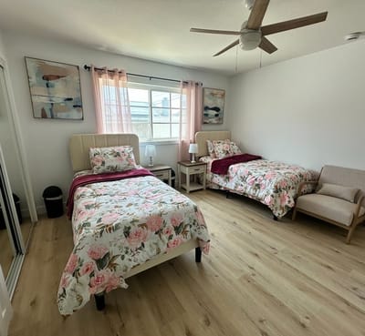 A cozy shared bedroom with two beds and decor
