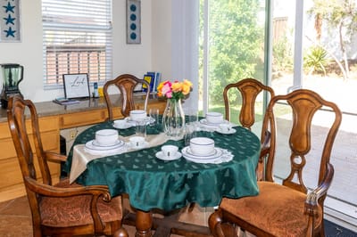 Dining table set with flowers and tableware