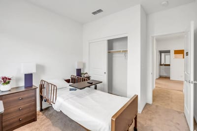 A private resident room with a bed and furnishings