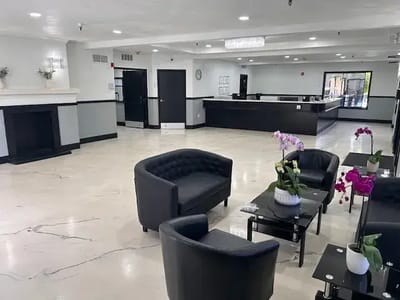 Interior of a modern lobby with seating and flowers