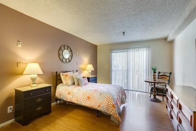 Private resident room with bed and decorative elements