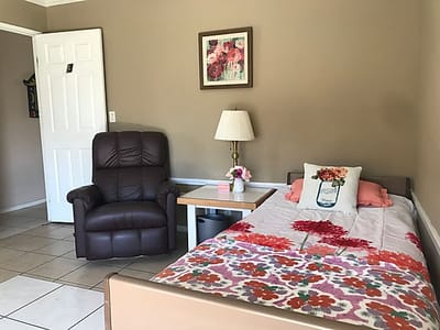 Cozy resident room with a bed and chair