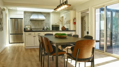 Bright common area with a dining table and kitchen