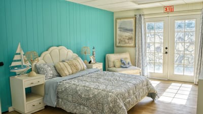 Brightly decorated private resident room with door to patio