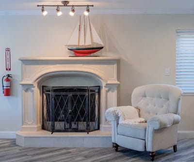 Cozy common area with a fireplace and chair