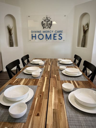 Dining area setup with plates and bowls on a wooden table