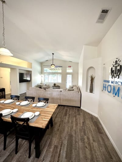 Bright common area with cozy seating and dining table