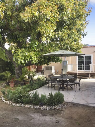Patio area with outdoor seating and shade.