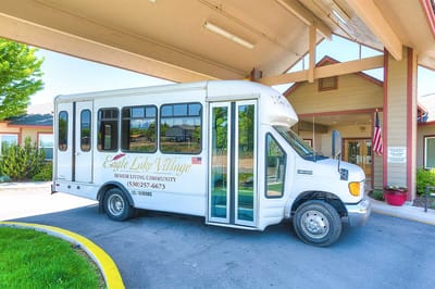Facility shuttle bus parked under the entrance awning