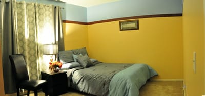 Cozy private room with bed and lamp