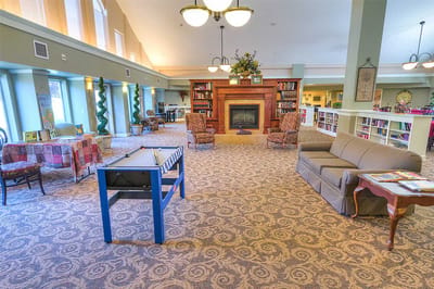 Bright common area with seating and a fireplace