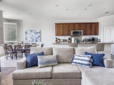 Bright and welcoming common area with seating and kitchen.