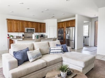 Bright common area with seating and kitchen view