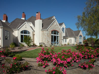 Exterior view of the Edna Rose Residence with flowers