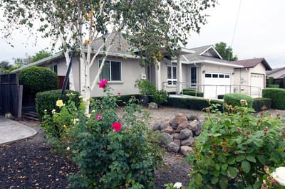 Exterior view of a house with flowers and shrubs