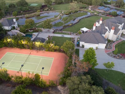 Aerial view of a tennis court and surrounding grounds