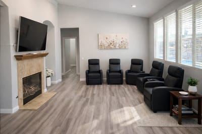 Cozy common area with recliners and a fireplace