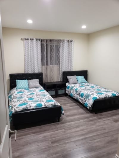 A well-furnished shared bedroom with two beds