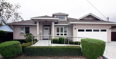 Exterior view of a residential care home with ramps