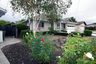 Exterior view of a senior living facility with flowers