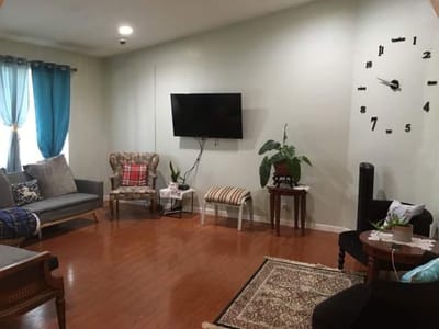 Bright common area with seating and clock
