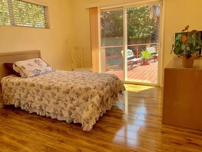 Brightly lit resident room with a view of the outdoor deck