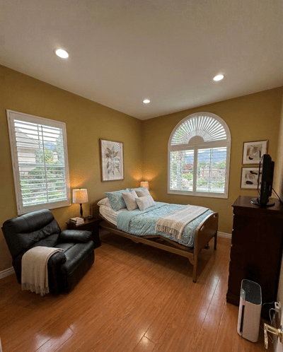 Cozy private resident room with a bed and chair
