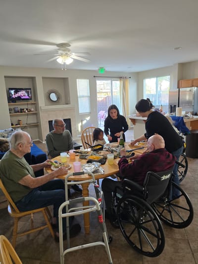 Residents and staff sharing a meal together