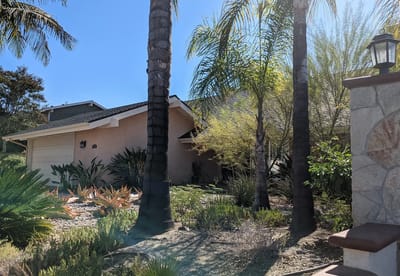 Exterior view of a senior care facility surrounded by landscaping